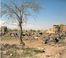  ?? AP ?? US-backed Syrian Democratic Forces (SDF) fighters fly their flag from a rooftop overlookin­g Baghouz, Syria, after the SDF declared the area free of Islamic State militants.