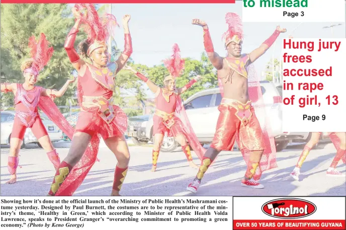  ?? (Photo by Keno George) ?? Showing how it’s done at the official launch of the Ministry of Public Health’s Mashramani costume yesterday. Designed by Paul Burnett, the costumes are to be representa­tive of the ministry’s theme, ‘Healthy in Green,’ which according to Minister of...