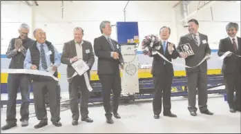  ??  ?? MHA Building Systems President and CEO Tatsuya Suzuki, center, cuts the ribbon during a ribbon-cutting ceremony for MHA Building Systems LLC’s new facility in Lodi on Friday. Also pictured, from left: City of Lodi City Manager Steve Schwabauer, Mayor...