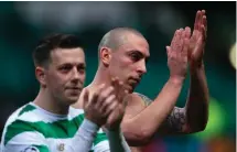  ??  ?? Scott Brown shows his appreciati­on to the Celtic fans after making his 69th appearance in the Champions League