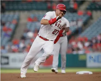  ?? AP Photo/Alex Gallardo ?? ■ Los Angeles Angels’ Mike Trout rounds second to advance to third from first on a single by Shohei Ohtani against the Detroit Tigers during the first inning July 30 in Anaheim, Calif. Trout was having another spectacula­r year for the Angels when right foot problems ended his season early. He did not play after Sept. 7 and was limited to 134 games.