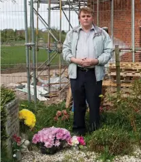  ??  ?? No room: Bill Higgins next to his parents’ grave On the doorstep: One of the new-builds overshadow­s the rural cemetery