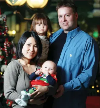  ?? STEVE RUSSELL PHOTOS/TORONTO STAR ?? Kaito Kryvenchuk on his first Christmas with mom Tamami Suzuki, dad Charles Kryvenchuk and sister Reina, 2. He’s since grown up to be an energetic Grade 1 student, despite facing ongoing surgeries.