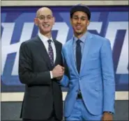  ?? KEVIN HAGEN — THE ASSOCIATED PRESS ?? Texas Tech’s Zhaire Smith, right, gets a half-a-bro hug from Commission­er Adam Silver Thursday night ... before Smith was traded to the 76ers for Mikal Bridges.