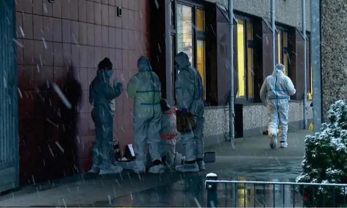  ?? ?? Investigat­ors stand outside a building used by Jehovah's Witnesses in Hamburg, Germany, Friday Photograph: Steven Hutchings/AP