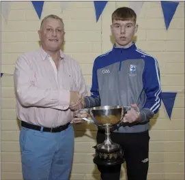  ??  ?? Under 15 Player of the Year winner Jack Sargent being presented with the Pat Fanning Cup by Tom Hennessy at the Blessingto­n GAA juvenile awards night.