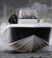  ?? PHOTO BY SAUL LOEB/AFP VIA GETTY IMAGES, FILE ?? U.S. President George W. Bush (left) and former US President George H.W. Bush (right) take Russian President Vladimir Putin (center) for a ride in the Bush family boat in the Atlantic Ocean off of Kennebunkp­ort, Maine, July 1, 2007.