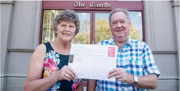  ??  ?? Community campaign activists Kerry Elliott and Rob Sinnett display the petition which is being widely circulated throughout West Gippsland. They are hoping thousands of people will sign it.