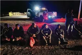  ?? Gregory Bull/Associated Press ?? Migrants wait to be processed after crossing the border on Jan. 6, near Yuma, Ariz. The Biden administra­tion says it will generally deny asylum to migrants who show up at the U.S. southern border without first seeking protection in a country they passed through. That mirrors an attempt by the Trump administra­tion that never took effect because it was blocked in court.