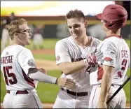  ?? NWA Democrat-Gazette/BEN GOFF ?? Arkansas Razorbacks catcher Alex Gosser (center) jokes with teammates Jake Arledge (left) and Jared Gates after a home run against Georgia last Thursday. Gosser has been productive in limited action this season and is batting .389 with 4 RBI in 10 games.