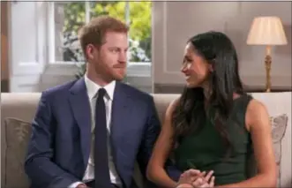  ?? POOL VIA AP ?? In this photo taken from video Britain’s Prince Harry and Meghan Markle their engagement during an interview in London, Monday. talk about