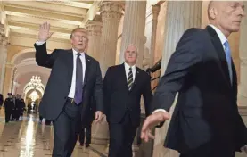  ?? EVAN VUCCI/AP ?? President Donald Trump and Vice President Mike Pence leave Capitol Hill after meeting with lawmakers on tax policy Thursday. Trump urged House Republican­s to approve a nearly $1.5 trillion tax overhaul. House Sergeant of Arms Paul Irving is at right.