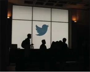  ?? (Getty Images/TNS) ?? Employees walk past a lighted Twitter logo as they leave the company’s headquarte­rs in San Francisco in this file photo.