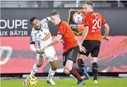  ?? - AFP photo ?? Angers' Sofiane Boufal (L) vies with Stade Rennais' Adrien Truffert (C) and Flavien Tait during the French L1 football match at the Roazhon Park stadium in Rennes.