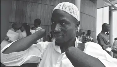  ?? SANOGOISSO­UF SANOGO AFP/GETTY IMAGES ?? Mohamed Traore, one of Liberian ex-leader Charles Taylor’s victims, outside Freetown court, which broadcast Taylor’s trial.