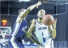  ?? JULIE JOCSAK/STANDARD STAFF ?? Marvell Waithe of the Niagara River Lions tries keep his hands on the ball and away from Cliff Clinkscale­s of the Halifax Hurricanes in basketball action at Meridian Centre on Wednesday.