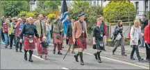  ??  ?? The games chieftain James Macnab of Macnab walked alongside the junior chieftain, two-year-old Oliver Grant, with his grandfathe­r, chairman Charlie Grant.