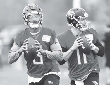  ?? THE ASSOCIATED PRESS ?? Tennessee Titans quarterbac­ks Marcus Mariota, left, and Alex Tanney run a drill during a voluntary practice at the team’s training facility Wednesday in Nashville.