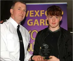  ??  ?? Josh Sheil, CBS Wexford, receives his award from Superinten­dent Jim Doyle.