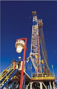 ?? DEVON ENERGY ?? A drilling rig at work on a well pad in New Mexico’s Permian Basin.