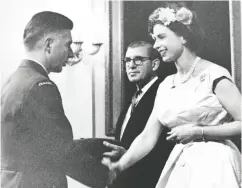  ?? CANADIAN FORCES ?? Squadron Leader A.G. (Andy) Carswell receives the Air Force Cross from Queen Elizabeth in a ceremony at Government House in Ottawa on Dominion Day, July 1, 1959.