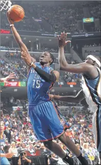  ?? NIKKI BOERTMAN / THE COMMERCIAL APPEAL ?? Oklahoma City reserve guard Reggie Jackson slips past the Grizzlies’ Zach Randolph on his way to the hoop during Game 4. Jackson finished with 32 points to lead the Thunder to the OT victory.