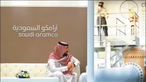  ?? REUTERS ?? A Saudi Aramco employee sits in his company stand at the Middle East Petrotech, an exhibition and conference for the refining and petrochemi­cal industries, in Manama, Bahrain.