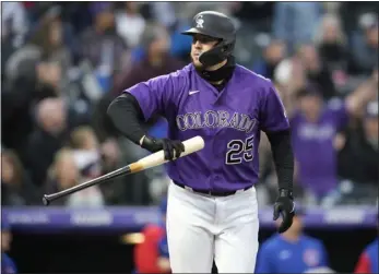 ?? DAVID ZALUBOWSKI — ASSOCIATED PRESS ?? The Rockies’ C.J. Cron tosses his bat after hitting a two-run home run off Chicago Cubs starting pitcher Mark Leiter Jr. during the third inning of a baseball game on April 16in Denver.