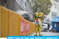 ??  ?? WUHAN: A medical staff member sprays disinfecta­nt at a residentia­l area in Wuhan in China’s central Hubei province yesterday. —AFP