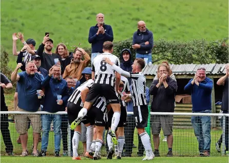  ?? PICTURES: Simon Howe ?? Bath City celebrate Jordan Thomas’ winner to progress in the FA Cup at the expense of rivals Larkhall Athletic, having come back from two goals down