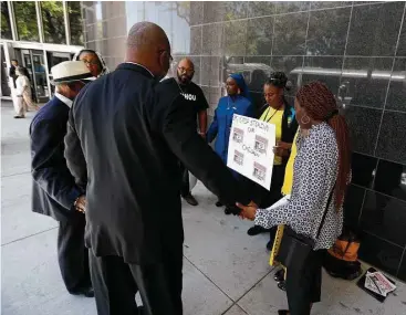  ?? Karen Warren / Houston Chronicle ?? The Rev. Robert Muhammad leads a prayer Tuesday outside the federal courthouse in Houston. “The bellwether of what’s going on in the black community is how our children are being traded in foster care for money,” he said.