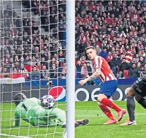  ?? Picture: Shuttersto­ck. ?? Saul Niguez beats Liverpool keeper Alisson to give Atletico an early lead.