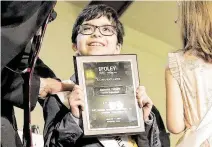  ??  ?? Brandon Curbow, from Crespo Elementary School, flashes a winner’s smile as he receives his first-place award and $1,000.