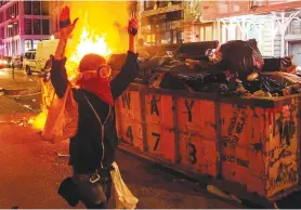  ?? (Eduardo Munoz/Reuters) ?? A PROTESTER in Manhattan walks with his hands up while looting on Monday, after marching against the death of George Floyd.