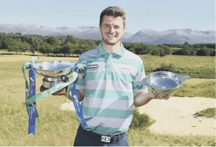  ??  ?? 0 More Scottish success is on its way, says Hazlehead player David Law, pictured with his Scottish Hydro Challenge trophy and his award for finishing as the top Scot in the tournament at Aviemore which concluded on Sunday.