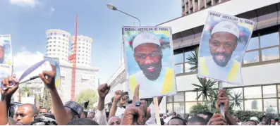  ?? AP ?? Placards showing Sheik Abdullah el-faisal are held up by demonstrat­ors in Nairobi, Kenya on January 15, 2010, protesting the arrest of the radical Jamaican-born Muslim cleric who was jailed because Kenyan authoritie­s said he was a threat to the security of their country. El-faisal who was accused of recruiting support for the Islamic State group and was extradited to New York City after an undercover New York Police Department sting that went internatio­nal, was convicted on Thursday of state terrorism charges.