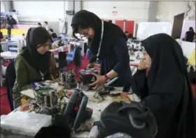  ?? VAHID SALEMI — THE ASSOCIATED PRESS ?? Iranian students prepare their robots during the internatio­nal robotics competitio­n, RoboCup Iran Open 2016, in Tehran, Iran. Universiti­es in the U.S. say President Donald Trump’s revised travel ban would block hundreds of graduate students who play...