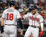  ??  ?? Ender Inciarte (right) celebrates with teammates after hitting a three-run home run against the Diamondbac­ks in the ninth inning on Sept. 9.