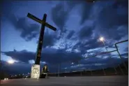  ?? CHRISTIAN CHAVEZ — THE ASSOCIATED PRESS ?? A woman sits next to a sign with a message that reads: ¨No More Guns! Make Love” on Saturday in Juarez, Mexico, where people gathered for a vigil for the Mexican nationals who were killed in an El Paso shopping-complex shooting.