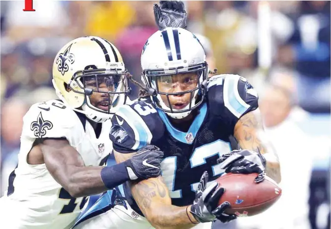  ?? — AP ?? ORLEANS: Carolina Panthers wide receiver Kelvin Benjamin (13) tries to pull in a pass as New Orleans Saints cornerback Ken Crawley (46) covers in the first half of an NFL football game in New Orleans, Sunday.