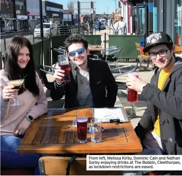  ??  ?? From left, Melissa Kirby, Dominic Cain and Nathan Sorby enjoying drinks at The Bobbin, Cleethorpe­s, as lockdown restrictio­ns are eased.