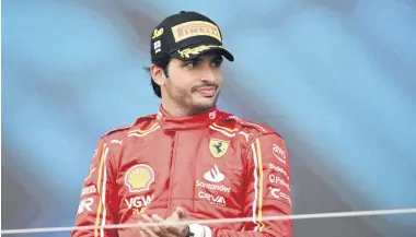  ?? ?? Ferrari’s Spanish driver Carlos Sainz stands on the podium after finishing third in the Formula One Japanese Grand Prix race at the Suzuka circuit, Suzuka, Japan, April 7, 2024.