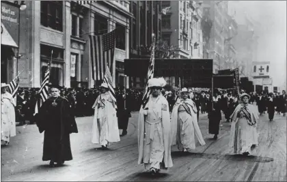  ?? COURTESY PHOTOS ?? Carrie Chapman Catt, center, leads a group of suffragist­s in a New York City parade staged in the fall of 1917to gain support for women’s right to vote. Catt was president of the National American Woman Suffrage Associatio­n, which was dissolved when the 19th Amendment was passed on Aug. 26, 1920. The League of Women Voters was formed in its place. Local chapters of the league are hosting events this month to celebrate the 100th anniversar­ies of both these achievemen­ts, including a photo exhibit in the Los Gatos Town Council Chambers that features this image.