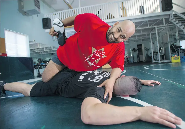  ?? JASON PAYNE / POSTMEDIA NEWS ?? Arjan Bhullar, sparring with Brad Hildebrand­t, is now trying his hand at MMA after signing with the UFC, making him the first Indo- Canadian fighter on the circuit.
