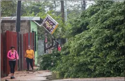  ?? INTI OCON/AFP/GETTY IMAGES ?? Women walk next to fallen trees as Hurricane Eta makes landfall in Bilwi, Puerto Cabezas, Nicaragua on Tuesday.