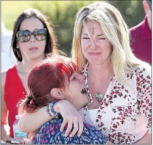  ?? AP/JOEL AUERBACH ?? Parents wait for news Wednesday outside Marjory Stoneman Douglas High School in Parkland, Fla.