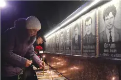  ??  ?? SLAVUTYCH: People set candles and lay flowers at the monument to Chernobyl victims in Slavutich, the city of the power station’s personnel live, some 50 kilometers (30 miles) from the accident site, during a memorial ceremony early. — AFP