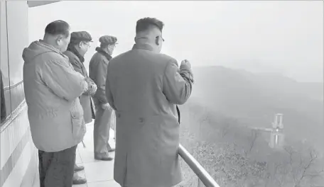  ?? Korean Central News Agency ?? NORTH KOREAN leader Kim Jong Un, right, observes the testing of a rocket engine at the Sohae satellite launching facility on the country’s west coast in an undated photo. Taking a cue from China, North Korea has built several islands, albeit not as...