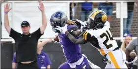  ?? (Pine Bluff Commercial/I.C. Murrell) ?? Central Arkansas wide receiver Tobias Enlow stiff-arms Arkansas-Pine Bluff defender Keyvien Johnson on his way to the end zone during the second quarter Saturday night at Estes Stadium in Conway.