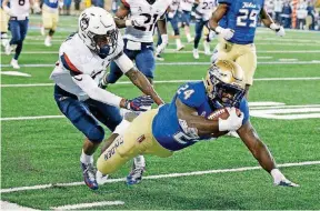  ?? [AP PHOTO] ?? Tulsa’s Corey Taylor scores a touchdown during last week’s win against Connecticu­t. The Golden Hurricane hope to carry that momentum into Saturday’s game at Memphis.